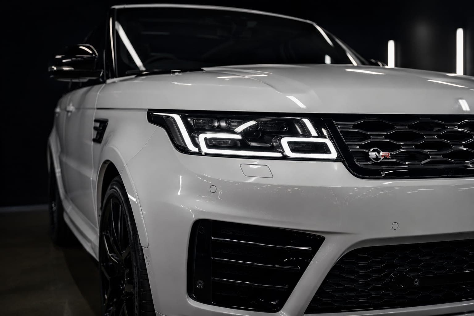 A pristine white Range Rover Sport SVR — the customer back on the road after the claim has been recovered
